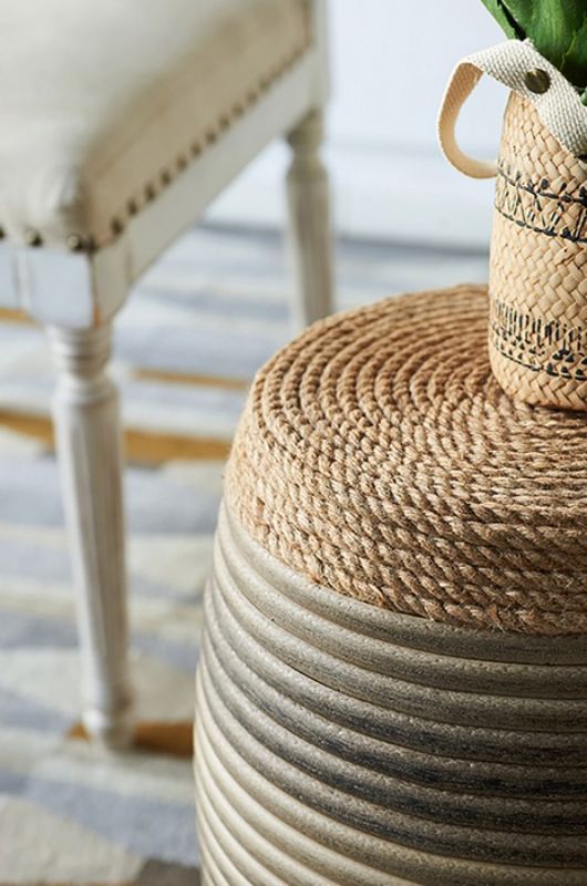 Rattan Drum Ottoman featuring vibrant rope wrap, barrel shape, and blue-gray tones, perfect for decor and casual seating.