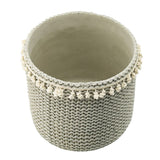 Stylish set of 2 sage green rattan planters with tassel trim, perfect for indoor or outdoor plant displays.