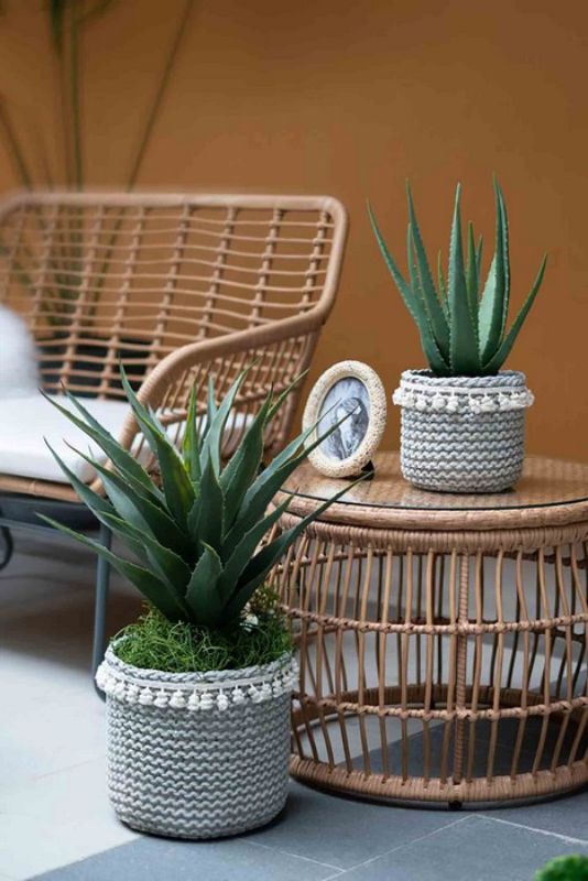 Stylish sage green rattan planters set of 2 with tassel trim, perfect for indoor and outdoor plant displays.