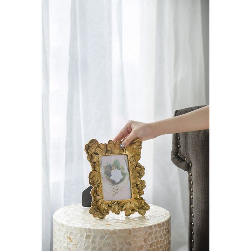 Elegant Art Deco-inspired 27cm photo frame in gold polyresin, perfect for showcasing cherished memories in style.