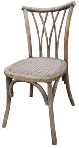 Elegant dining chair in antique oak, featuring a sturdy elm frame and intricately woven rattan seat, perfect for rustic settings.