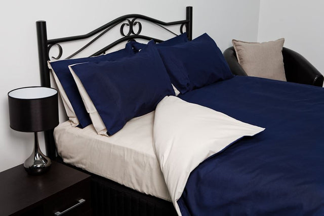 Reversible blue and oyster single duvet cover set with standard pillowcase, made from soft, durable polyester-cotton blend.