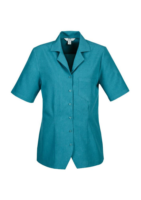 Teal ladies overblouse in size 20 featuring action back pleats, side splits, and a chest pocket for versatile comfort.