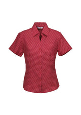 Ladies cherry short sleeve shirt with unique print, breathable fabric, and stylish curved hem for versatile wear. Size 10.