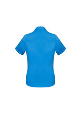 Vibrant cyan Ladies Monaco Short Sleeve Shirt for women, featuring a Y-neckline, elegant darts, and versatile longer length.