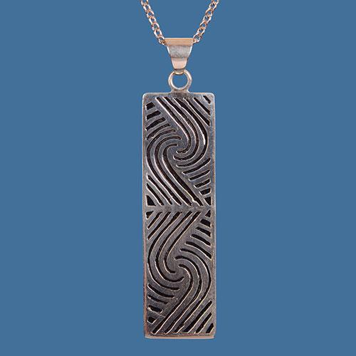 Handcrafted Maori design pendant in silver-plated brass, showcasing New Zealand's cultural heritage, perfect for gifts or personal style.