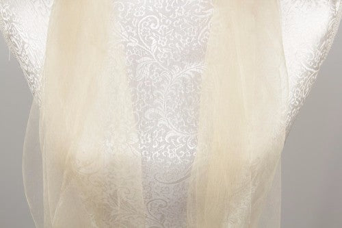 Luxurious cream silk wrap measuring 180cm x 70cm with 10cm tassels, perfect for elevating any outfit.
