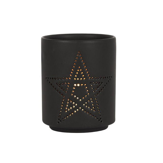 Small black ceramic tealight holder with pentagram cut-out, casting enchanting shadows and enhancing cozy atmospheres.