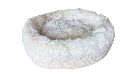 Cream-colored calming pet bed with a soft padded center, ideal for larger pets to curl up and feel secure. 90cm diameter.