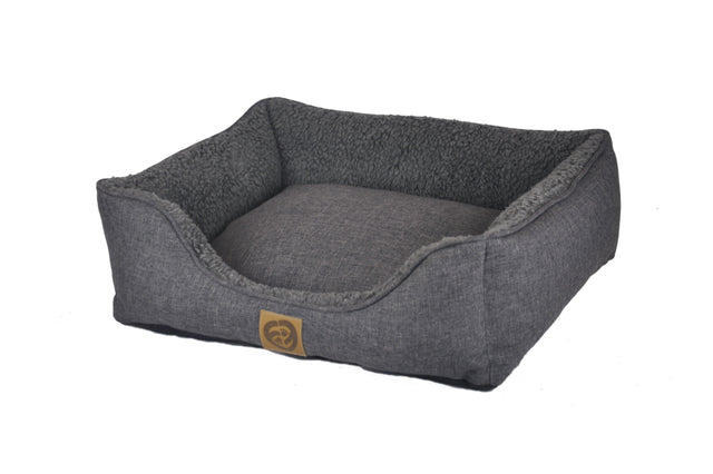 Cozy small Sherpa Pillow Bed for dogs, measuring 55x45x16cm, featuring plush fleece and supportive bolstered edges.