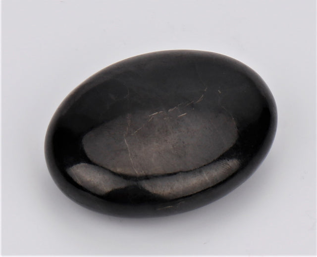 Shungite Flat Palm Stone, 5x4x1cm, absorbs EMF radiation, promotes wellness, and enhances energetic balance.