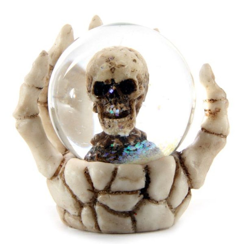 Set of 4 skull snow globes in skeleton hands, perfect for Halloween decor and gothic collections, measuring 6.5 cm tall.
