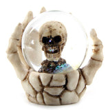 Set of 4 skull snow globes in skeleton hands, perfect for Halloween decor and gothic collections, measuring 6.5 cm tall.