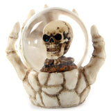 Set of 4 spooky snow globes featuring skulls in skeleton hands, perfect for Halloween and gothic decor.