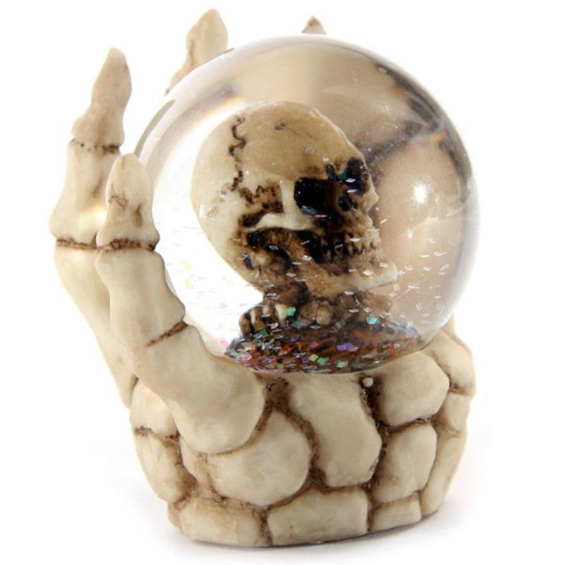 Set of 4 snow globes featuring skulls in skeleton hands, perfect for Halloween and gothic decor enthusiasts.