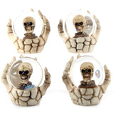 Set of 4 spooky snow globes featuring skulls in skeleton hands, perfect for Halloween and gothic decor.