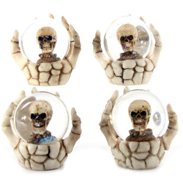 Set of 4 spooky snow globes featuring skulls in skeleton hands, perfect for Halloween and gothic decor.