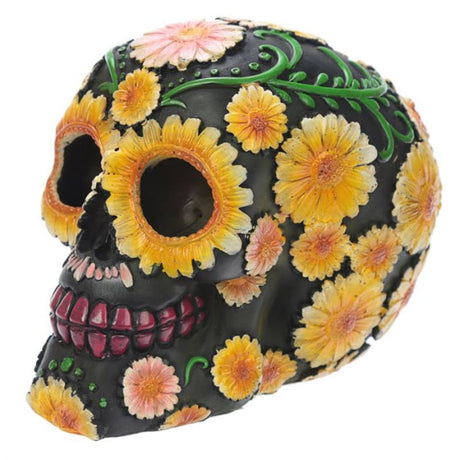 Day of the Dead skull ornament with vibrant daisy motif, crafted from durable resin, symbolizing remembrance and cultural celebration.