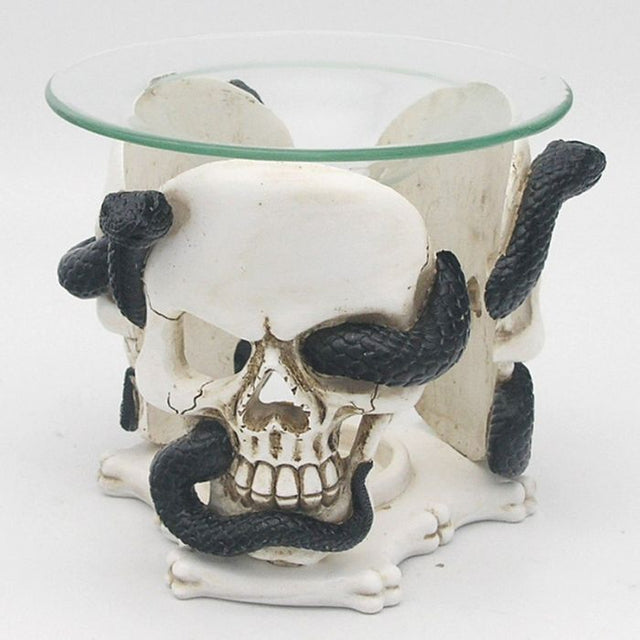 Gothic resin oil and wax burner featuring skull and serpent designs, includes a glass dish for safe melting of fragrances.