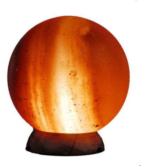 A warm, glowing Himalayan salt lamp ball, 18cm x 14cm, purifies air and enhances well-being in any decor.