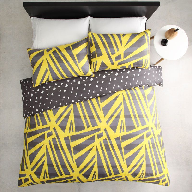 Vibrant single duvet cover set in spliced yellow and white, featuring reversible design and matching pillowcase for stylish bedding.