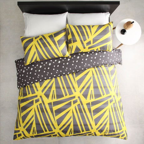 Vibrant single duvet cover set in spliced yellow and white, featuring reversible design and matching pillowcase for stylish bedding.