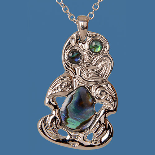 Colorful Tiki Paua Pendant on a rhodium chain, symbolizing ancestral connections and rich cultural heritage.