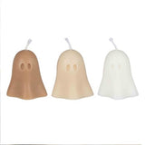 Three charming ghost-shaped candles in pumpkin spice decor, perfect for Halloween and autumn gatherings.