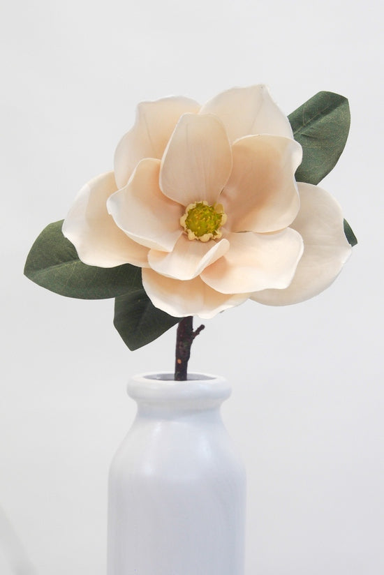 Lifelike cream magnolia flower stem with six blooms and three buds, ideal for elegant home decor and floral arrangements.