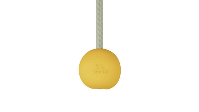 Eco-friendly yellow dog toy with rubber ball and recycled rope, perfect for fetch and tug games. Vanilla scented for added fun.