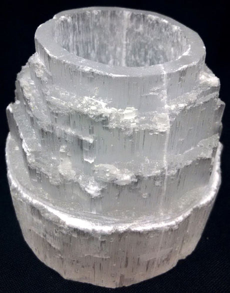 Elegant 9cm Selenite candle holder with a unique skyscraper design, perfect for creating a serene ambiance with tea lights.