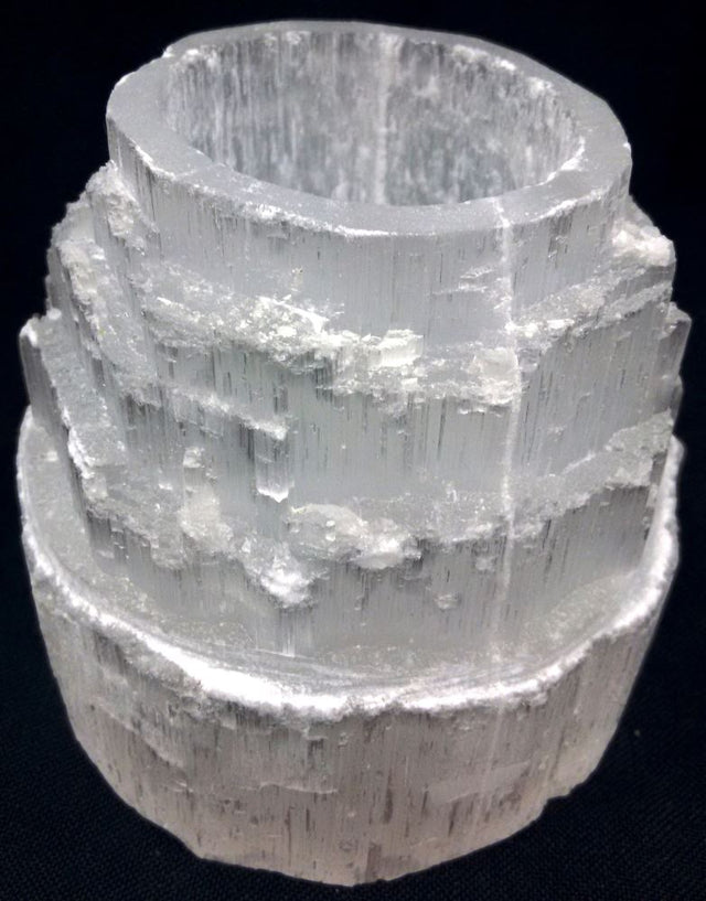 Elegant 9cm Selenite candle holder with a unique skyscraper design, perfect for creating a serene ambiance with tea lights.