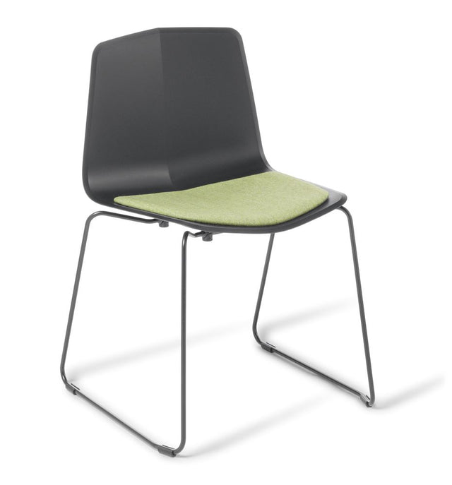 Modern black upholstered Stratos Sled chair with white shell and black sled frame, perfect for versatile seating in any space.