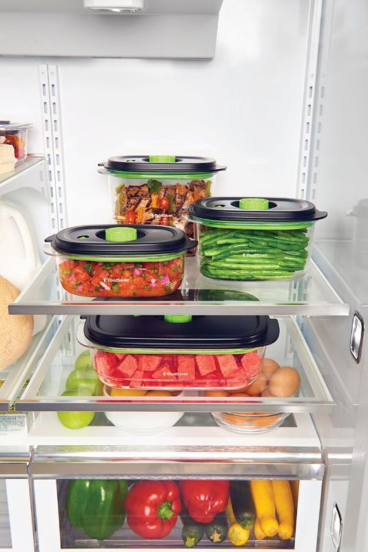 Vacuum-sealed 8-cup container by Sunbeam for preserving and marinating food, BPA-free, and compatible with FoodSaver machines.