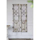 Elegant white decorative door with intricate metal grillwork, perfect for adding rustic charm to any interior space.