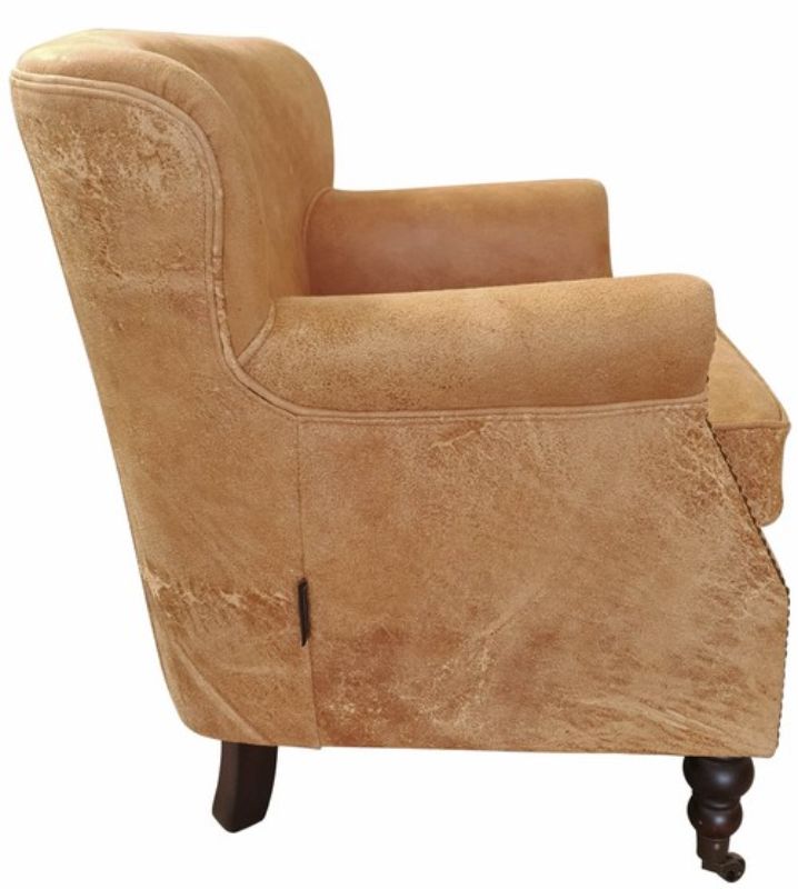 Stylish Mortimer Bigger armchair in distressed camel leather, featuring a solid timber frame and plush high-density foam seating.