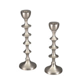 Small tiered candle holder in lustrous silver aluminum, perfect for elegant home decor and creating warm atmospheres.