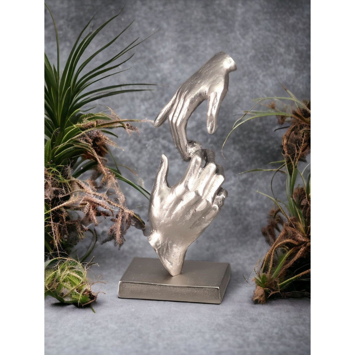 Elegant Aluminium Silver hands sculpture on sleek black base, showcasing modern artistry and sophistication for home decor.