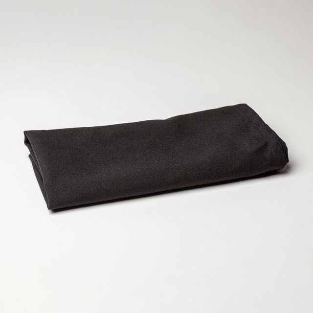 Elegant black 53 x 53cm Caress napkin, crafted from stain-resistant spun polyester for fine dining and events.