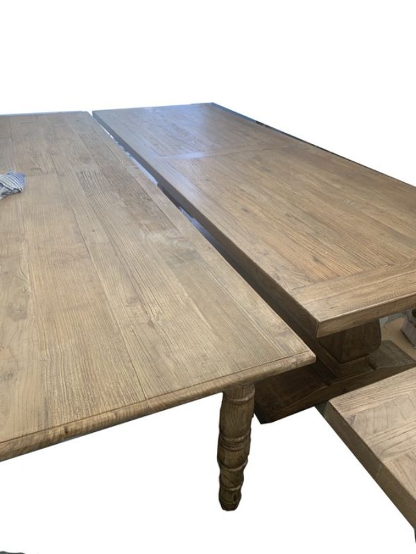 Elegant reclaimed elm dining table, 3m long, shows unique wood grain, perfect for 8 diners, with carved legs and natural finish.