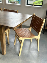 Natural elm dining chair with faux leather upholstery, designed for comfort and stylish elegance in any dining room.