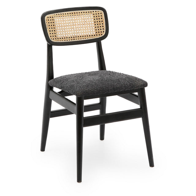 Modern black dining chair with boucle fabric and rattan back, featuring a sturdy elm frame for comfort and style.