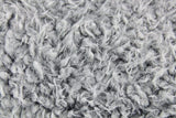 Luxurious double-sided faux sheep throw in black with white ends, perfect for cozying up and enhancing home decor.