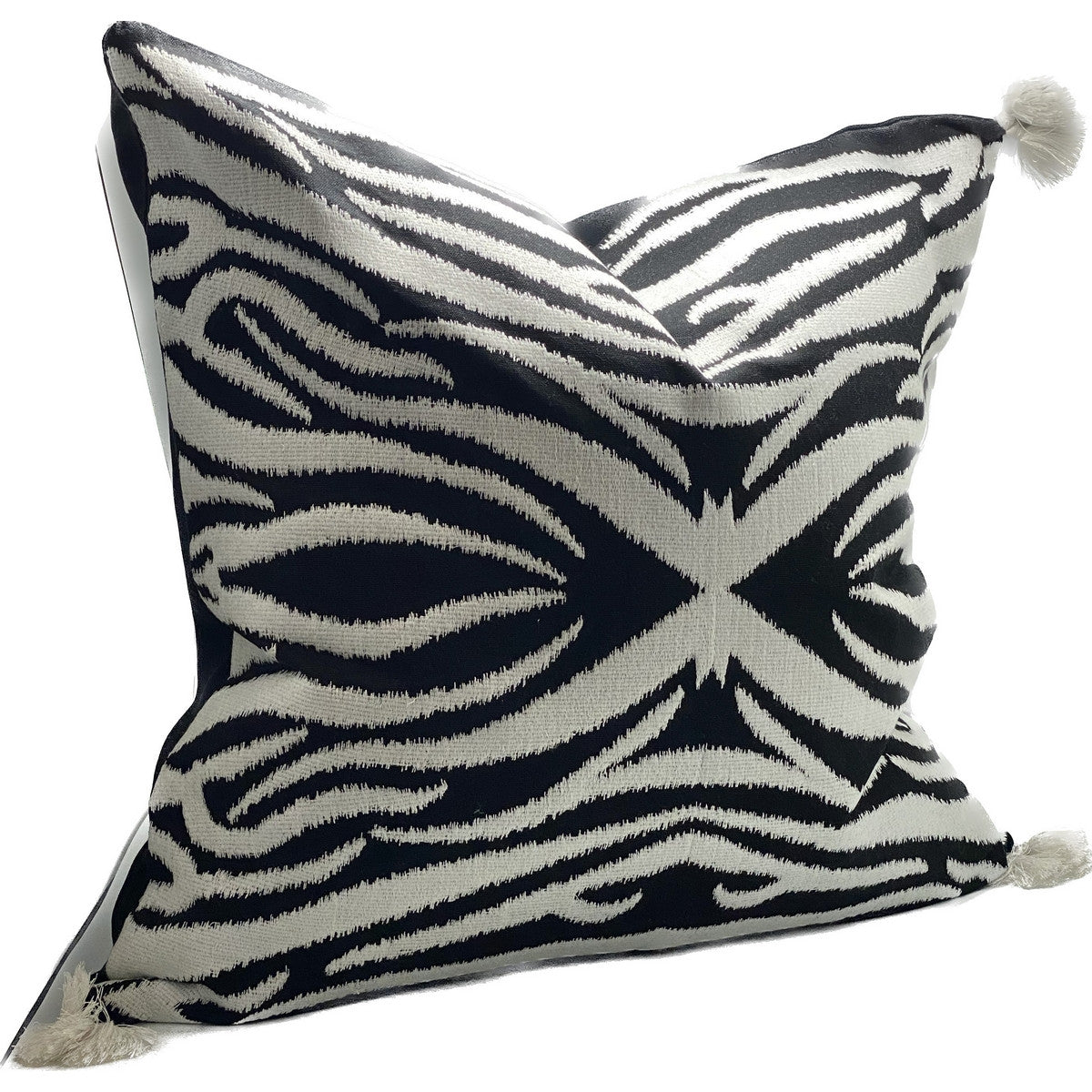 Hand-embroidered black and white cushion cover with tassels, adding elegance to any room's decor.