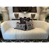 Hand-embroidered black and white cushion cover with tassels, adding elegance and sophistication to any room decor.