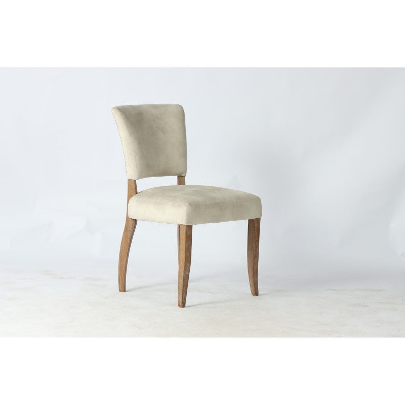 Elegant Derringer Dining Chair in Eskimo Velvet with silver studs, featuring a sturdy ash wood frame for luxurious seating.