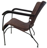 Luxurious buffalo leather armchair with a solid metal frame, perfect for modern and industrial interiors.