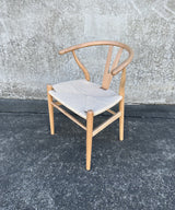 Elegant Wishbone Chair in Natural/White with Rattan seat and Beech wood frame, perfect for modern dining and stylish interiors.