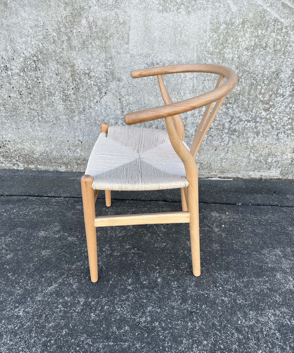 Elegant Wishbone Chair in Natural/White featuring rattan seat and beech wood frame, perfect for stylish home decor.