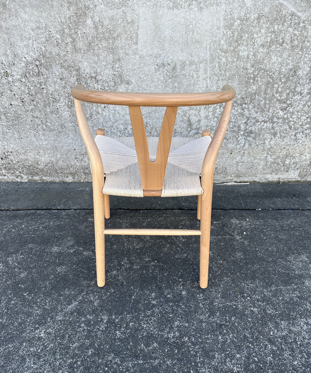 Stylish Wishbone Chair in natural and white, featuring rattan seat and beech wood frame, perfect for modern interiors.